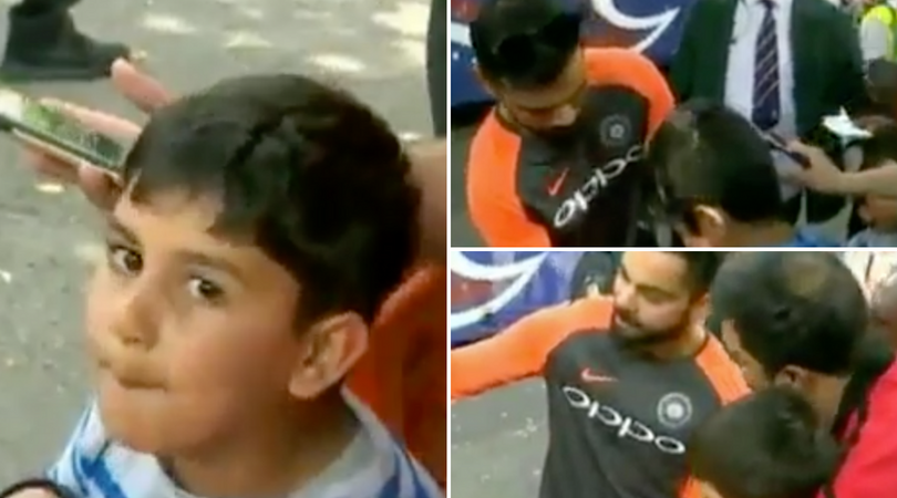 Kohli poses with fan for a picture