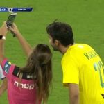 Referee shows Kaka yellow card before taking a selfie with him during a game