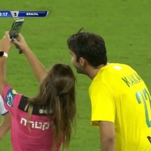 Referee shows Kaka yellow card before taking a selfie with him during a game