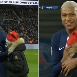 Kylian Mbappe signs an autograph for a young pitch invader in a beautiful moment during PSG vs Amiens