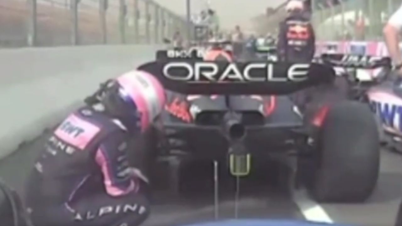 41-year-old Fernando Alonso and future Aston Martin teammate Lance Stroll inspect Max Verstappen's RB18 rear-wing