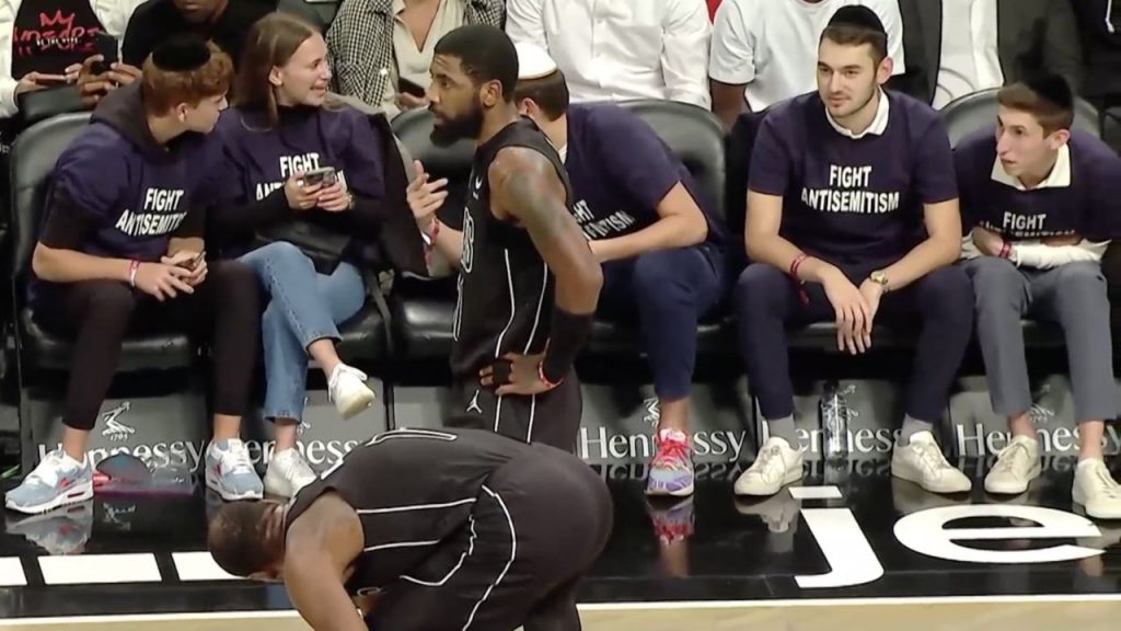 NBA Twitter Reacts to Kyrie Irving Being Welcomed by Fans at Courtside Wearing "Fight Antisemitism" T-Shirts