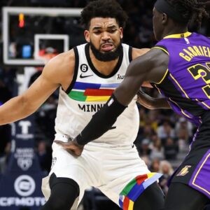 Mar 31, 2023; Minneapolis, Minnesota, USA; Minnesota Timberwolves center Karl-Anthony Towns (32) dribbles while Los Angeles Lakers forward Wenyen Gabriel (35) defends during the third quarter at Target Center. Mandatory Credit: Matt Krohn-USA TODAY Sports