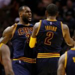Kyrie Irving (2) and LeBron James (23) celebrate a Cavaliers lead before a timeout