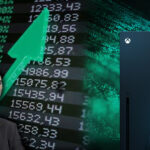 An image showing the Xbox with controllers and rising stock image with a suited man