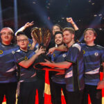 An image showing Evil Geniuses team memebers holding Valorant Champions 2023 trophy with their coach