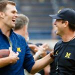 Michigan HC Jim Harbaugh Suited To Be NFL Bound With Raiders and Bears