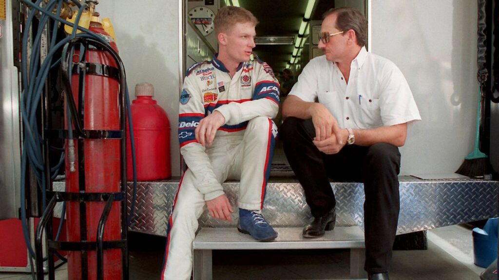 May 21, 1998 - Concord, NC, USA - Dale Earnhardt Jr. and Dale Earnhardt Sr., sit on the back of a transporter discussing Earnhardt Jr. s preparation for Carquest 300 Grand National qualifications on May 21, 1998 in Concord, N.C. Dale Earnhardt Jr. to retire