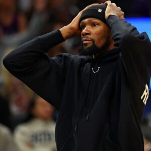 Is Kevin Durant Playing Tonight vs Heat? Suns Release Injury Report for 2x NBA Champ During the final fixture of the 2023 calendar year, Kevin Durant felt tightness in his right hamstring. Even though he played the entirety of the contest against the Orlando Magic, the injury was serious enough to get him to be sidelined for the next two games. Yet again, the Phoenix Suns have added the 2014 MVP’s name to the injury report. However, fans will be pleased to learn that Kevin Durant has been upgraded to “questionable” after being listed as “OUT” for the past couple of clashes. Suns injury report vs. Heat: QUESTIONABLE: Kevin Durant (right hamstring strain), Eric Gordon (right knee soreness), Nassir Little (left knee soreness). OUT: Damion Lee (knee). — Ira Winderman (@IraHeatBeat) January 5, 2024 Recently, during an interview, head coach Frank Vogel provided a positive injury update and disclosed that Durant was deemed as day-to-day with his injury. Frank Vogel said the #Suns medical team still see something with Kevin Durant's hamstring, but Durant is still "day-to-day." pic.twitter.com/W1gfGZzsp4 — Duane Rankin (@DuaneRankin) January 4, 2024 Kevin Durant has been stupendous when he has been on the court this season. However, while things are looking up when it comes to his injury status, the Suns also need to prepare for the scenario where Durant is not healthy enough to play.  The Phoenix Suns are 4-2 without Kevin Durant in the lineup Kevin Durant is an integral part of the Phoenix Suns. However, the Suns have stood firm even in Durant’s absence. In the six games that the team has played with KD not suiting up, the Suns have had a winning 4-2 record. Apart from suffering losses against two – the Clippers & the Kings – Western Conference powerhouses, the Suns defeated the Grizzlies, the Knicks, the Warriors, and the Blazers. Even if the two-time NBA champion were to miss out on tonight’s clash, the Bradley Beal and Devin Booker-led Phoenix Suns would be regarded as the favorites, since the Miami Heat are set to miss out on Jimmy Butler’s services for yet another game. #MIAvsPHX INJURY UPDATE: Jimmy Butler (right toe MP Joint irritation) and Orlando Robinson (G League assignment) have both been ruled out of tomorrow night’s game vs the Suns. Caleb Martin (ankle) is listed as doubtful. — Miami HEAT (@MiamiHEAT) January 4, 2024 It’s safe to assume that the Suns would miss the presence of Durant. The big man has been their best player and has recorded some impressive numbers – 29.9 points, 6.3 rebounds, and 6 assists per game. It’ll be interesting to see whether or not the duo of Beal and Booker can step up if their All-Star counterpart ends up missing the clash.