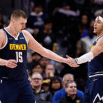 Dec 14, 2023; Denver, Colorado, USA; Denver Nuggets center Nikola Jokic (15) reacts with forward Aaron Gordon (50) in the second quarter against the Brooklyn Nets at Ball Arena.