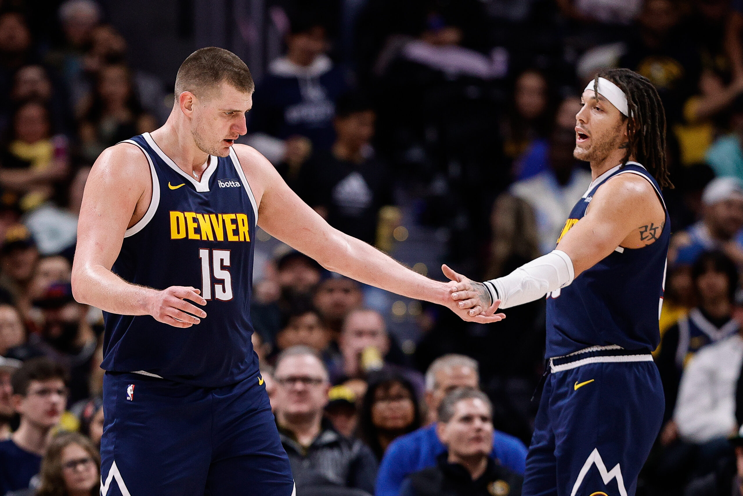 Dec 14, 2023; Denver, Colorado, USA; Denver Nuggets center Nikola Jokic (15) reacts with forward Aaron Gordon (50) in the second quarter against the Brooklyn Nets at Ball Arena.