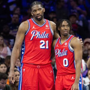 Philadelphia 76ers center Joel Embiid (21) and guard Tyrese Maxey (0) stand together during a break in action in the fourth quarter against the Orlando Magic at Wells Fargo Center.