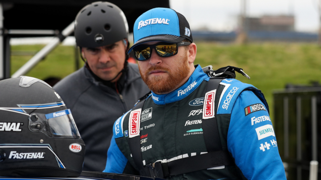 Apr 27, 2024; Dover, Delaware, USA; NASCAR Cup Series driver Chris Buescher climbs into his car during practice and qualifying for the Wurth 400 at Dover Motor Speedway. Mandatory Credit: Matthew O'Haren-USA TODAY Sports
