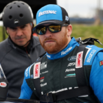 Apr 27, 2024; Dover, Delaware, USA; NASCAR Cup Series driver Chris Buescher climbs into his car during practice and qualifying for the Wurth 400 at Dover Motor Speedway. Mandatory Credit: Matthew O'Haren-USA TODAY Sports