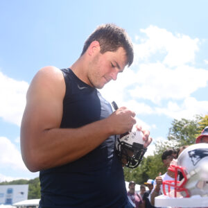 Drake Maye Finds Humor In Signing a Slashed Mac Jones Jersey Corrected With His Name