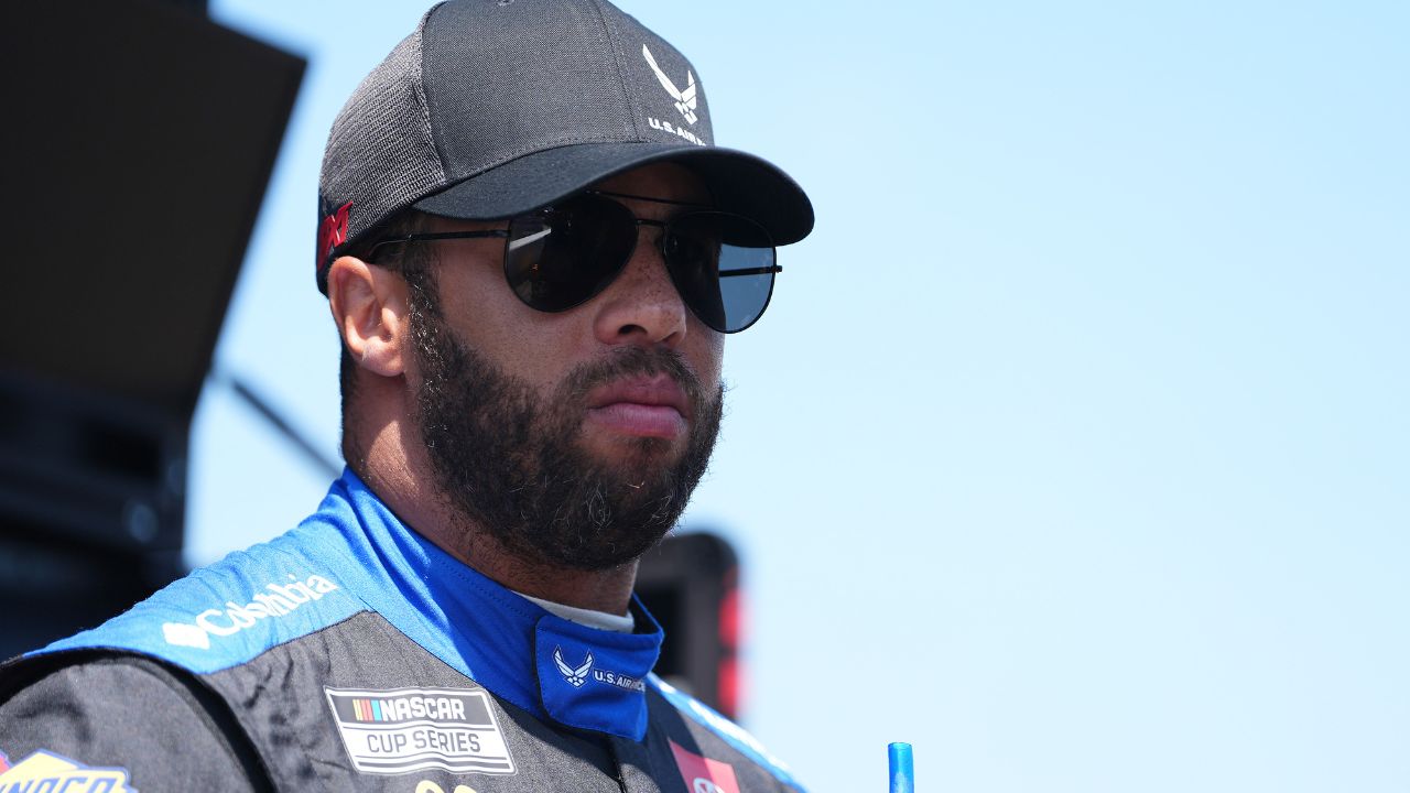 Aug 31, 2024; Darlington, South Carolina, USA; NASCAR Cup Series driver Bubba Wallace stands in his pit box prior to practice for the Cook Out Southern 500 at Darlington Raceway. Mandatory Credit: Jasen Vinlove-USA TODAY Sports