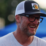 Jul 20, 2024; Hampton, VA, USA; Dale Earnhardt Jr. talks with former NASCAR driver Elliot Sadler before the 16th Annual Hampton Heat at Langley Speedway. Mandatory Credit: Peter Casey-Imagn Images