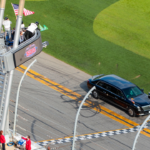 The car containing President Donald Trump crosses the start finish line as he drives on the apron of the track prior to the Daytona 500 at Daytona International Speedway.