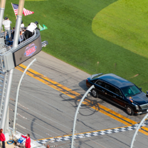 The car containing President Donald Trump crosses the start finish line as he drives on the apron of the track prior to the Daytona 500 at Daytona International Speedway.