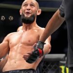 Khamzat Chimaev (red gloves) fights Kevin Holland (blue gloves) during UFC 279 at T-Mobile Arena.