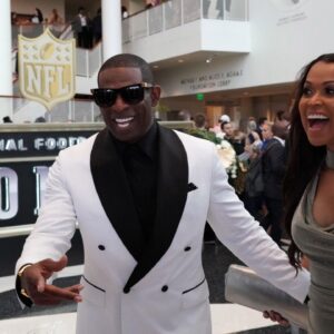 Deion Sanders (left) and Tracey Edmonds react during the NFL Honors awards presentation at Adrienne Arsht Center.
