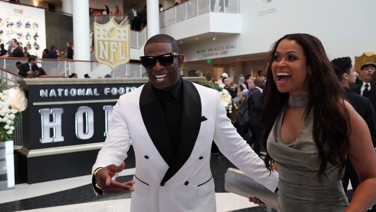 Deion Sanders (left) and Tracey Edmonds react during the NFL Honors awards presentation at Adrienne Arsht Center.