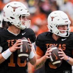 Texas Longhorns quarterbacks Arch Manning (16), left, and Quinn Ewers (3) throw passes while warming up ahead of the Longhorns' spring Orange and White game at Darrell K Royal Texas Memorial Stadium in Austin, Texas.