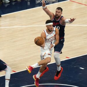 Phoenix Suns guard Devin Booker (1) is defended by LA Clippers center Ivica Zubac (40) in the first half at Intuit Dome