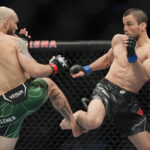 Brian Kelleher (red gloves) fights Umar Nurmagomedov (blue gloves) during UFC 272 at T-Mobile Arena.