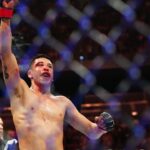 Brandon Moreno (red gloves) reacts after the fight against Alexandre Pantoja (blue gloves) during UFC 290 at T-Mobile Arena.