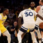 Los Angeles Lakers guard Bronny James (9) guards Minnesota Timberwolves forward Julius Randle (30) as Los Angeles Lakers forward LeBron James (23) guards Minnesota Timberwolves guard Joe Ingles (7) during the second quarter against the Minnesota Timberwolves at Crypto.com Arena. This marked the first time in NBA history that a father and son played together.