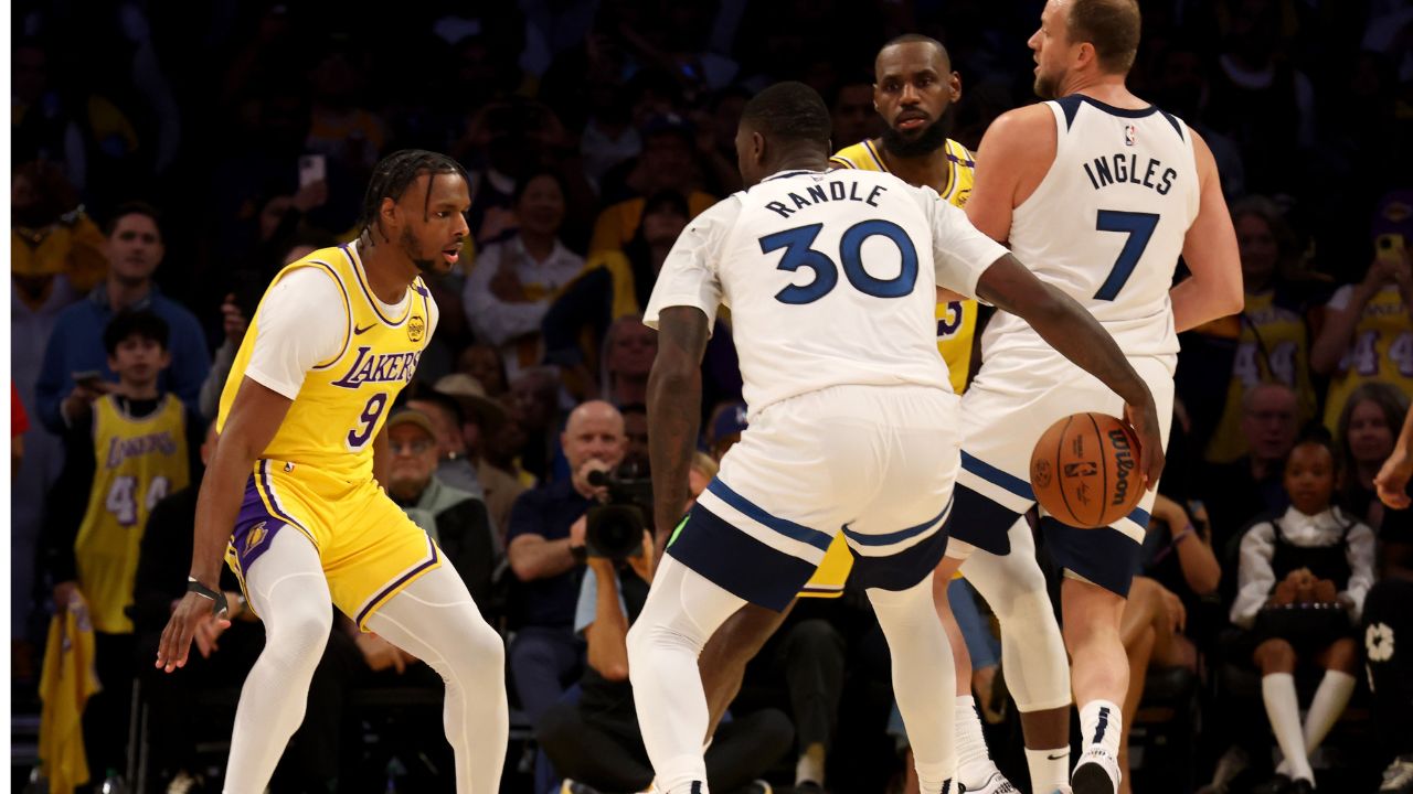 Los Angeles Lakers guard Bronny James (9) guards Minnesota Timberwolves forward Julius Randle (30) as Los Angeles Lakers forward LeBron James (23) guards Minnesota Timberwolves guard Joe Ingles (7) during the second quarter against the Minnesota Timberwolves at Crypto.com Arena. This marked the first time in NBA history that a father and son played together.