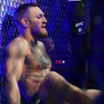 Conor McGregor reacts following an injury suffered against Dustin Poirier during UFC 264 at T-Mobile Arena.