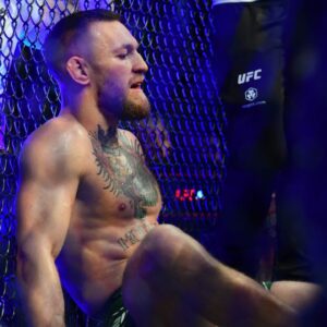 Conor McGregor reacts following an injury suffered against Dustin Poirier during UFC 264 at T-Mobile Arena.