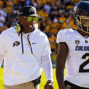 Colorado Buffaloes head coach Deion Sanders with son and quarterback Shedeur Sanders (2) against the Arizona State Sun Devils at Mountain America Stadium.