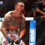 Max Holloway (blue gloves) reacts after defeating Justin Gaethje (not pictured) during UFC 300 at T-Mobile Arena.