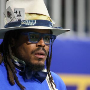 Former NFL quarterback Cam Newton watches a game between the Howard Bison and Florida A&M Rattlers in the first half at Mercedes-Benz Stadium.
