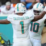 Miami Dolphins wide receiver Tyreek Hill (10) celebrates the touchdown of running back quarterback Tua Tagovailoa (1) during the second half at Hard Rock Stadium.
