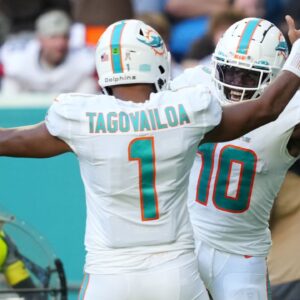 Miami Dolphins wide receiver Tyreek Hill (10) celebrates the touchdown of running back quarterback Tua Tagovailoa (1) during the second half at Hard Rock Stadium.