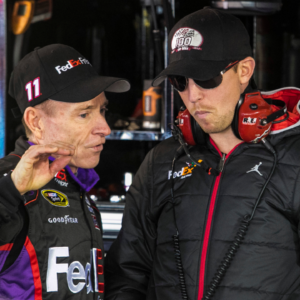 NASCAR Sprint Cup Series driver Mark Martin (11) talks with injured NASCAR Sprint Cup Series driver Denny Hamlin during practice for the STP Gas Booster 500 at Martinsville Speedway.