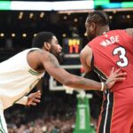 Miami Heat guard Dwyane Wade (3) controls the ball while Boston Celtics guard Kyrie Irving (11) defends during the first half at TD Garden.