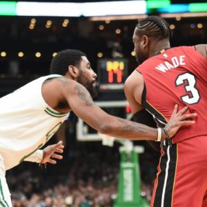 Miami Heat guard Dwyane Wade (3) controls the ball while Boston Celtics guard Kyrie Irving (11) defends during the first half at TD Garden.