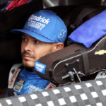 Driver for the Hendrick Motorsports Kyle Larson straps into the number 5 car before the FireKeepers Casino 400 on Sunday, Aug. 6, 2023.
