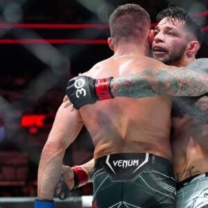 Daniel Pineda (red gloves) hugs Tucker Lutz (blue gloves) after defeating him during UFC Fight Night at AT&T Center.