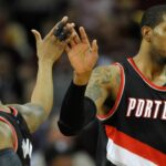 Jan 28, 2015; Cleveland, OH, USA; Portland Trail Blazers forward LaMarcus Aldridge (12) celebrates with guard Damian Lillard (0) in the third quarter against the Cleveland Cavaliers at Quicken Loans Arena.