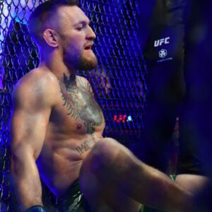 Conor McGregor reacts following an injury suffered against Dustin Poirier during UFC 264 at T-Mobile Arena.