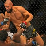 Khamzat Chimaev (red gloves) fights Kevin Holland (blue gloves) during UFC 279 at T-Mobile Arena.