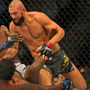 Khamzat Chimaev (red gloves) fights Kevin Holland (blue gloves) during UFC 279 at T-Mobile Arena.