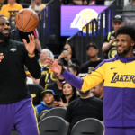 Los Angeles Lakers forward LeBron James (23) warms up with guard Bronny James (9) before the preseason game against the Golden State Warriors
