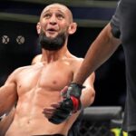 Khamzat Chimaev (red gloves) fights Kevin Holland (blue gloves) during UFC 279 at T-Mobile Arena.